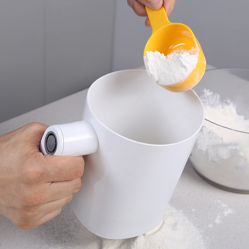 Scooping flour into the electric flour sifter